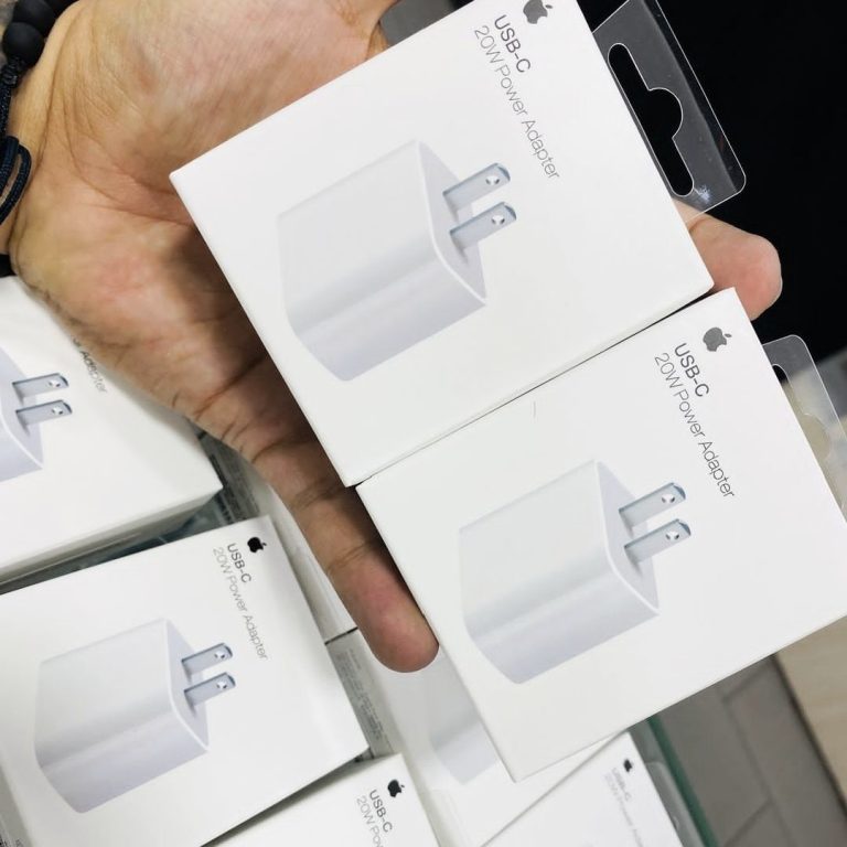 Hand holding Apple USB-C power adapter packaging