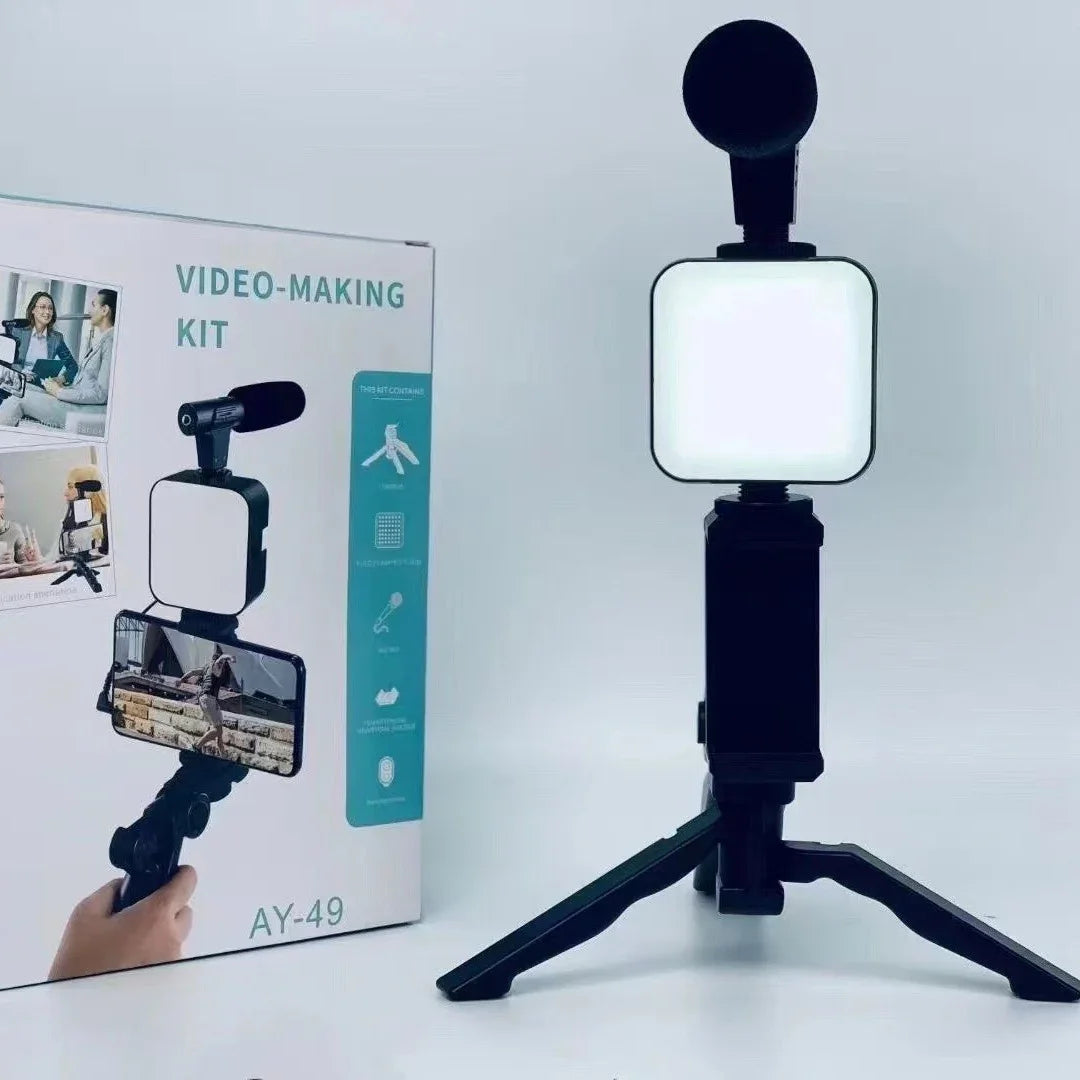 Video-making kit with light and microphone on a stand next to its packaging box.